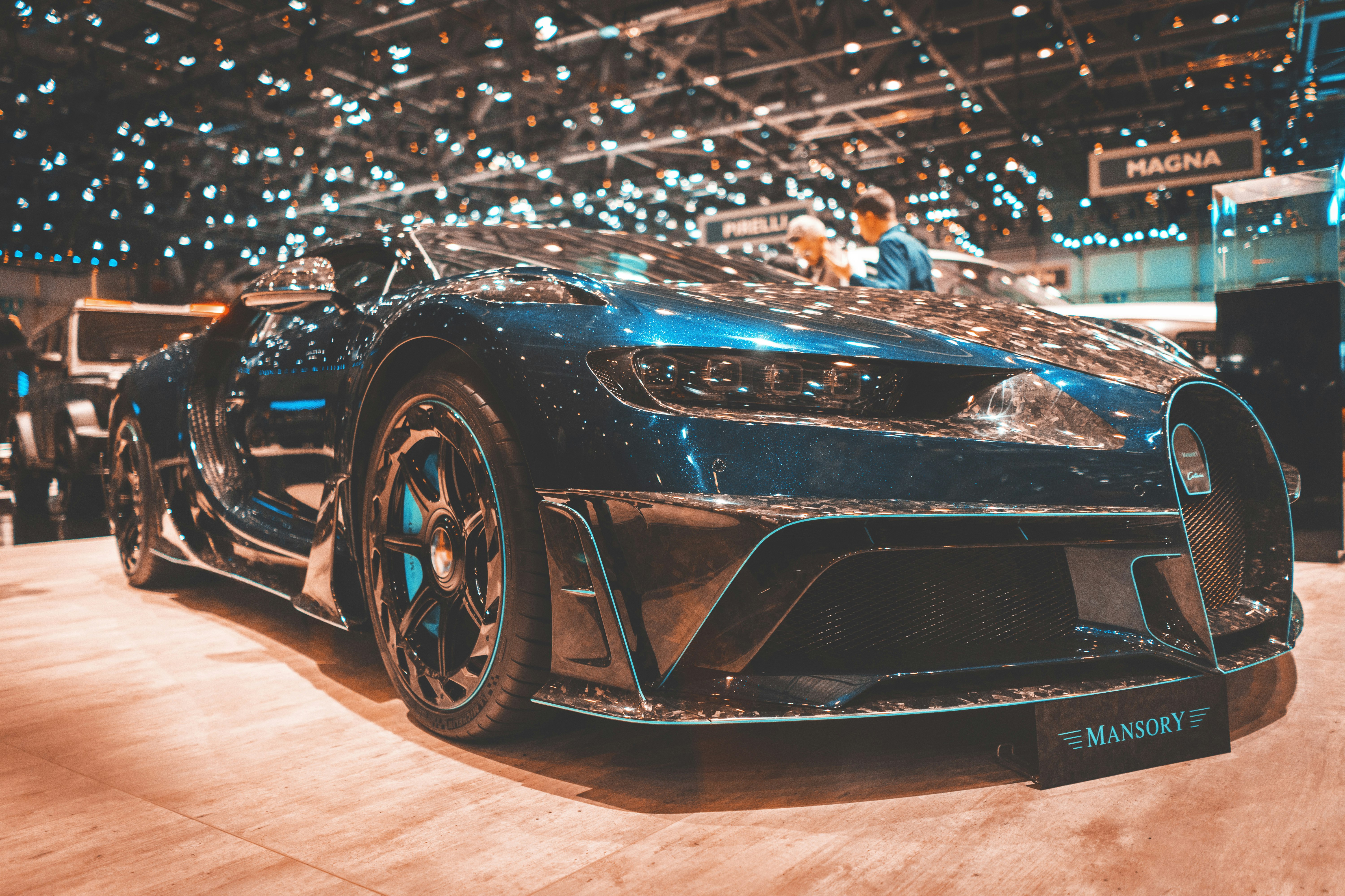 blue Bugatti Veyron parked in well-lit building